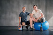 © peopleimages.com - Physiotherapy, kettlebell and man with disability for fitness, training and muscle strength with coach for support. Amputee, exercise ball and physiotherapist for physical rehabilitation with workout