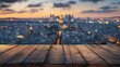 Blurred city view with wooden plank foreground - This image portrays a soft focus city vista at dusk with dewy wooden planks in the foreground, providing depth and context