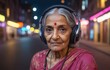 an elderly woman is wearing headphones and listening to music