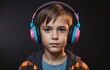 Portrait of a boy in headphones on a dark background. Close-up.