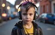 Portrait of a little boy listening to music with headphones in the city
