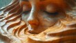 a close up of a wood carving of a woman's face with her eyes closed and her eyes closed.