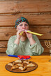 A Jewish woman with a kisuyi rosh whistles and claps at the women's celebration of the Purim carnival