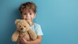 © PD - Little boy hugging stuffed toy on pastel blue background