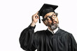 Thoughtful professor in graduation cap looking upward