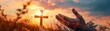 © Creative_Bringer - A hand reaches out towards a Christian cross in a symbolic gesture of faith and hope against a beautiful sunset backdrop.
