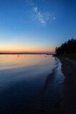 Fototapeta Nowy Jork - The Milky Way and Stars Start to Appear Over East Arm Grand Traverse Bay, Michigan at Sunset