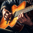 A close-up of a musicians hands playing a guitar.