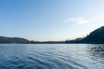 day time on mountain lake with calm water and cloudy sky