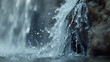 Close-up shot of water droplets splashing on rocks near waterfall