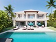 A beautiful beachfront house with a swimming pool and lounge chairs on the patio.