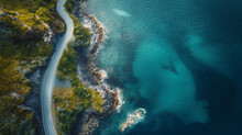 Aerial view of road, rocky sea coast with waves and stones at sunset in Lofoten Islands, Norway. Landscape with beautiful road, transparent blue water, rocks. Top view from drone of highway in summer.