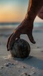 A man reaching for a ball on the beach with his hand. Generative AI.