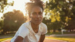 Black afro american woman in her 40s wearing white shirt top exercising outdoor looking directly at the camera