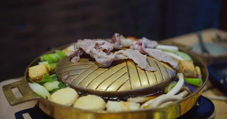 Wall Mural - A plate of food with meat and vegetables on top of a grill. The food looks delicious and appetizing