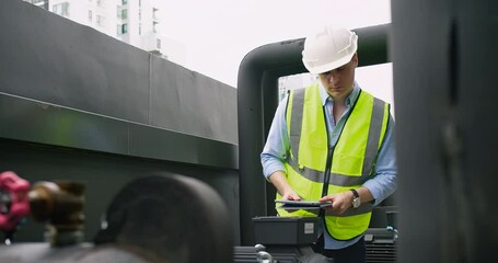 Wall Mural - A Engineer man looking inspecting maintenance insulated pipelines valve pump control on the roof at an industrial site. He is wearing a hard hat and safety vest