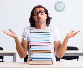 Wall Mural - Young male student sitting in the classroom