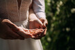 The image is a close-up photo of a woman and a man holding hands outdoors 6960.