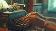 Close-up of a writer's hands using a vintage mechanical typewriter to create nostalgic and traditional documents in a retro office setting