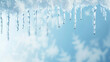 Clear icicles against a solid blue background, reflecting daylight.