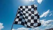 © JH45 - Waving checkered flag against blue sky background.