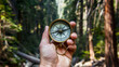 A compass, clutched in the hands of a forest, serves as a tool for determining the direction relative to the main geographical landmarks
