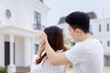 © Creativa Images - Young woman with her eyes covered by her husband while getting a surprise new house gift