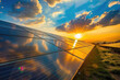 The sun sets majestically behind rows of modern solar panels in a renewable energy farm