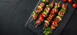 Juicy pork skewers with vegetables on a black stone plate. B-B-Q. View from above. place for text. generative ai