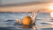 a fresh orange fell on the surface of the water bursting into a splash against of sunlit and blue background