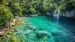 A panoramic view of a secluded cove with crystal-clear turquoise water, fringed by lush greenery and a hidden waterfall