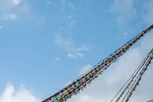 Tibetan Prayer Flags Isolated At Blue Sky Background 