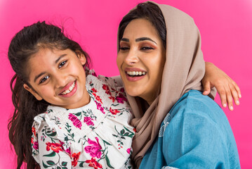 Wall Mural - Portrait of middle eastern mother and daughter wearing traditional abaya