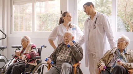 Wall Mural - Distracted doctors talking while senior people exercising in geriatric