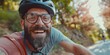 A bearded cyclist in a helmet and glasses smiles. Portrait of a biker in the park. Generative AI.