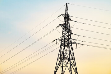 Silhouette High voltage electric tower on sunset time and sky on sunset time background.