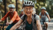 Active elderly pensioners riding a bicycle in the park, healthy lifestyle banner