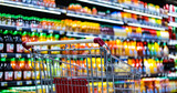 Fototapeta  - A shopping cart by a store shelf in a supermarket