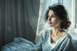 A realistic image of a woman sitting by a window in a hospital gown her gaze fixed outside