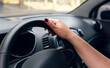 © JulioCsar - a woman's hand on the steering wheel of a car