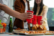© NINENII - drinks and conversation, social gathering and get together. Young people, group and happiness at fast food pizzeria, celebration at home.