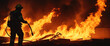 Silhouette of a fireman against the background of a large fire. Panorama.