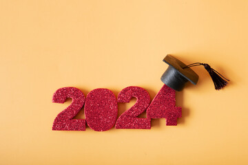 Wall Mural - Red number 2024 with graduated cap. Class of 2024 concept.