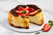Basque san sebastian cheesecake on a marble background with strawberries