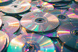 Stack of Compact Discs on top of each other in a disorganized pile, isolated on white background