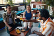 © DragonImages - Cheerful friends having drinks in bar after work