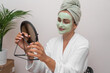 Home Beauty Oasis: A woman's skincare shines as she indulges in a moisturizing facial mask, unveiling beauty in her home sanctuary.