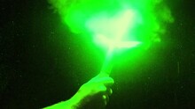 Green Flare Held Up In Dusty Cave
