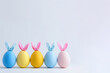 Easter composition of colorful easter eggs with funny colorful bunny ears. Copy space. Place for text. Easter discount banner.  Easter celebrating concept. Family values and traditions. Generative ai.