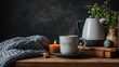 A tranquil still life that embodies the Danish concept of hygge, showcasing a warm drink, candle, blanket, and plant